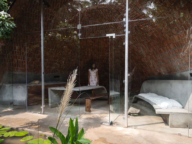 Interior bedroom framed by double-curved brick ceiling